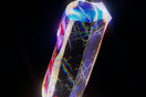 a very colorful diamond on a black background