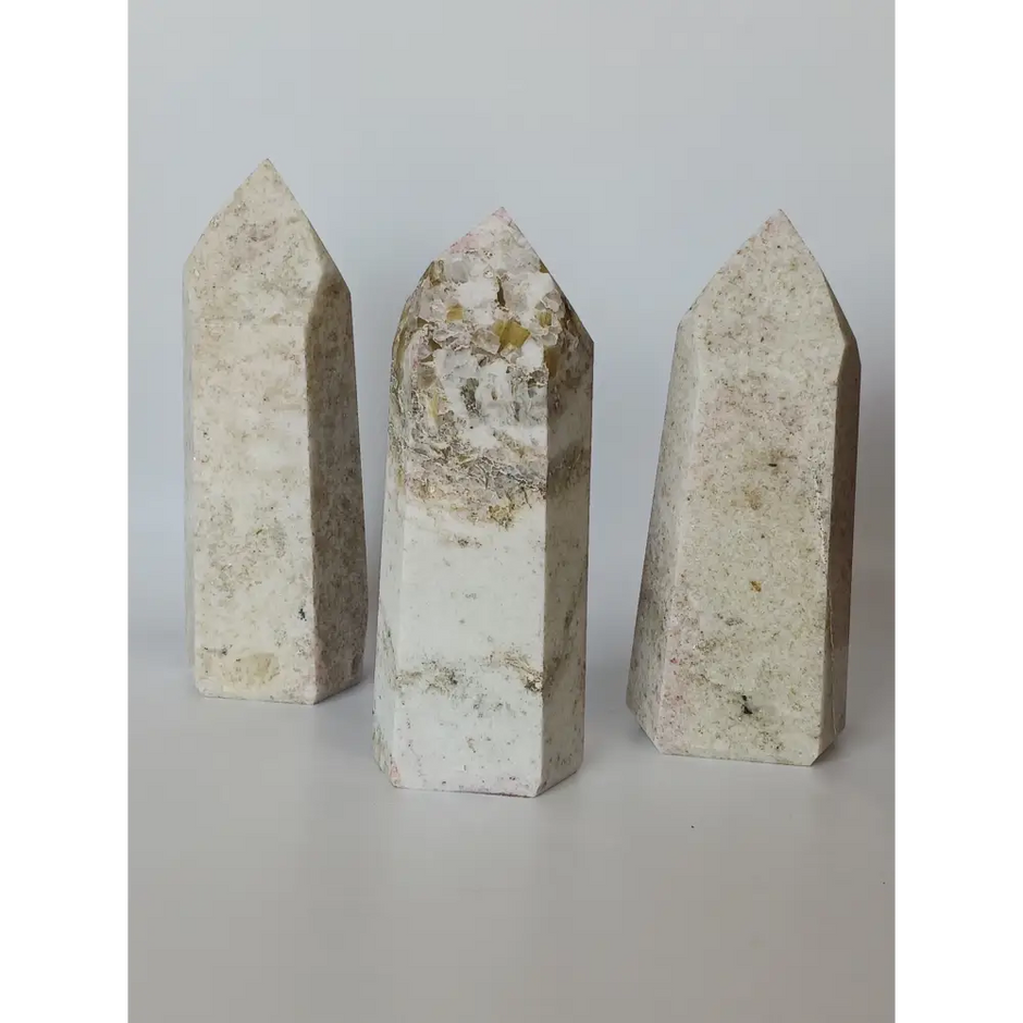 Hand-carved Albite Mica tower featuring radiant white albite with shimmering mica inclusions, displayed on a white background.