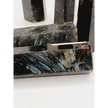 Astrophyllite (firework stone) with garnet tower, 2.5–3 inches, hand-polished with golden flashes and deep red inclusions, displayed on a white background.