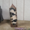 Hand-polished Black Septarian stone featuring bold yellow, brown, and black patterns, displayed on a white background.