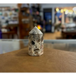 Hand-carved Mexican Crazy Lace Agate tower featuring intricate, colorful swirls and banded patterns, displayed on a white background.