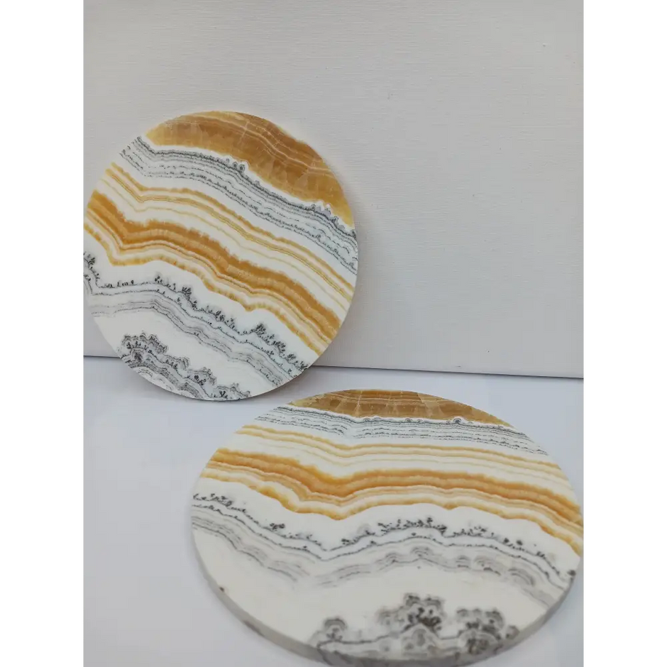 Dendritic Orange Calcite charging plate, 5.5 inches, with vibrant orange hues and natural dendritic patterns, displayed on a white background.
