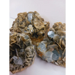 Muscovite with aquamarine specimen, showcasing shimmering layers and blue crystal accents, displayed on a white background.