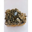 Muscovite with aquamarine specimen, showcasing shimmering layers and blue crystal accents, displayed on a white background.