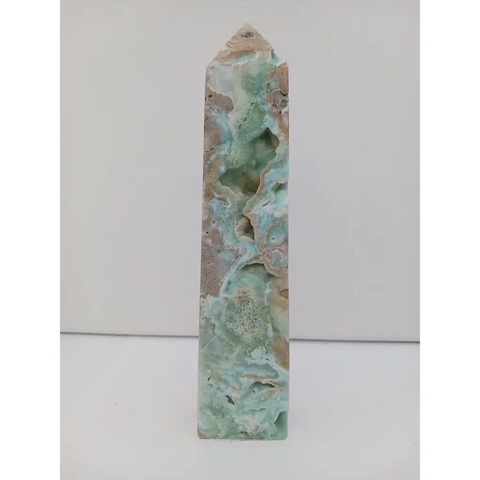 Hand-carved Gemy Hemimorphite tower with sparkling blue hues, displayed on a white background.