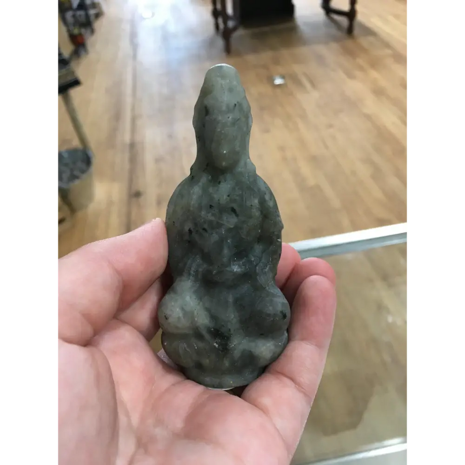 Hand-carved Goddess Guanyin statue made from genuine labradorite, featuring iridescent flashes of blue, green, and gold, displayed upright on a white background.