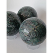 Hand-polished Green Mica sphere featuring sparkling, leafy-green hues and a glossy finish, displayed on a white background.