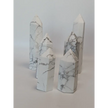 Hand-carved Howlite point featuring soft white coloring with graceful gray veining, displayed on a white background.