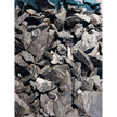 Raw Hypersthene chips with silvery-black flashes, displayed on a white background.
