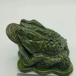 Hand-carved jade money frog with a rotating coin in its mouth, detailed and polished, displayed on a white background. Perfect for attracting prosperity, good fortune, and Feng Shui blessings.