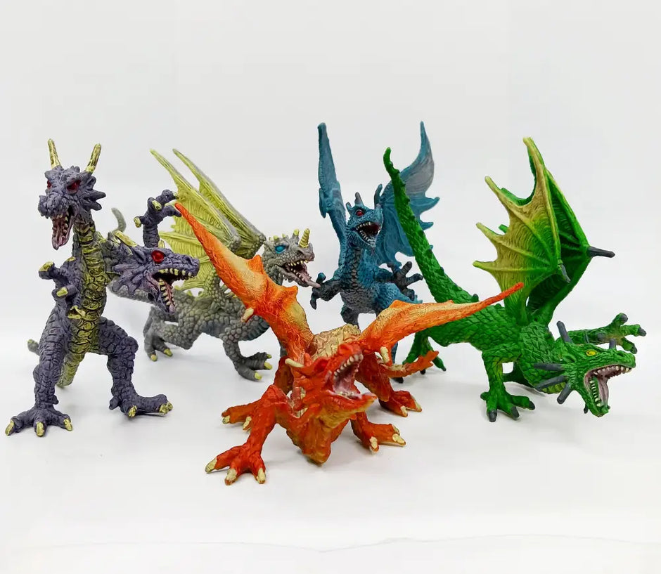 Set of colorful dragon figurines on a white background