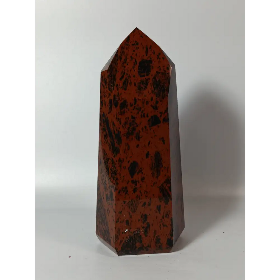 Hand-carved Mahogany Obsidian tower with rich brown and black swirls, displayed on a white background.