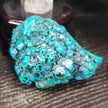 Malachite and chrysocolla specimen with vibrant green bands and blue-teal hues, displayed on a white background. Perfect for transformation, heart healing, and inner wisdom.