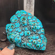 Malachite and chrysocolla specimen with vibrant green bands and blue-teal hues, displayed on a white background. Perfect for transformation, heart healing, and inner wisdom.