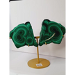 Pair of polished malachite slabs with vibrant green banding, displayed upright on a metal stand against a white background.