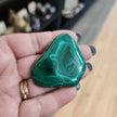 Hand-selected malachite specimen with vibrant green bands and natural patterns, displayed on a white background. Perfect for transformation, protection, and heart chakra healing.