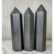 Hand-carved Noble Shungite tower featuring a lustrous, jet-black finish, displayed on a white background.