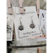 Sterling silver earrings featuring a radiant sun with the Om symbol at the center, displayed on a white background. Perfect for spiritual radiance, peace, and sacred style.