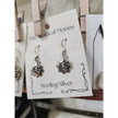Sterling silver earrings featuring a radiant sun with the Om symbol at the center, displayed on a white background. Perfect for spiritual radiance, peace, and sacred style.