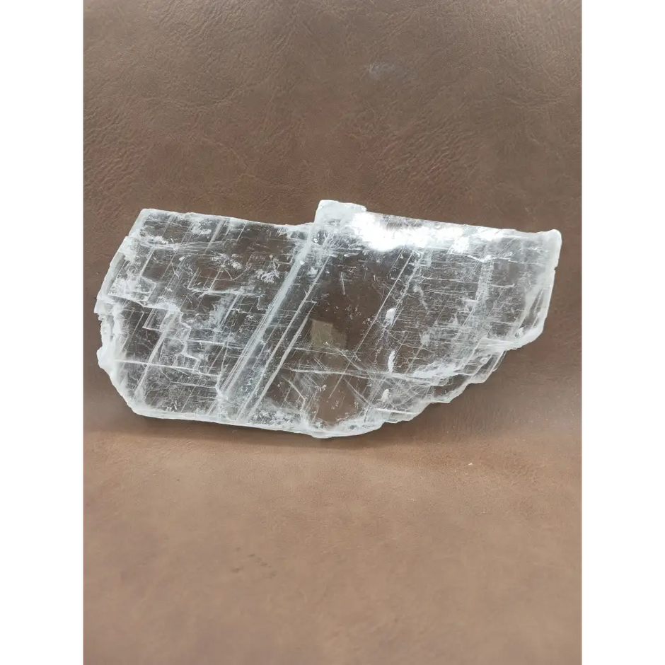 Pink selenite slab, polished with soft rosy hues, displayed on a white background.