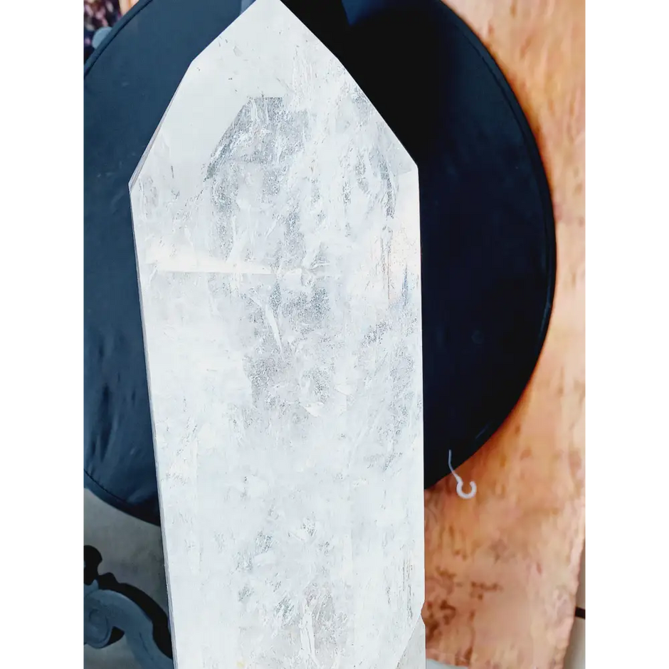 Diamantina clear quartz tower, 17 inches tall, polished with exceptional clarity and natural inclusions, displayed on a white background.