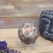 Hand-polished RARE Green Sakura Flower Agate featuring lush green tones and delicate, flower-like patterns reminiscent of cherry blossoms, displayed on a white background.