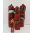 Hand-carved Red Jasper point with a clear quartz band, featuring vibrant red tones and a striking clear quartz stripe, displayed on a white background.