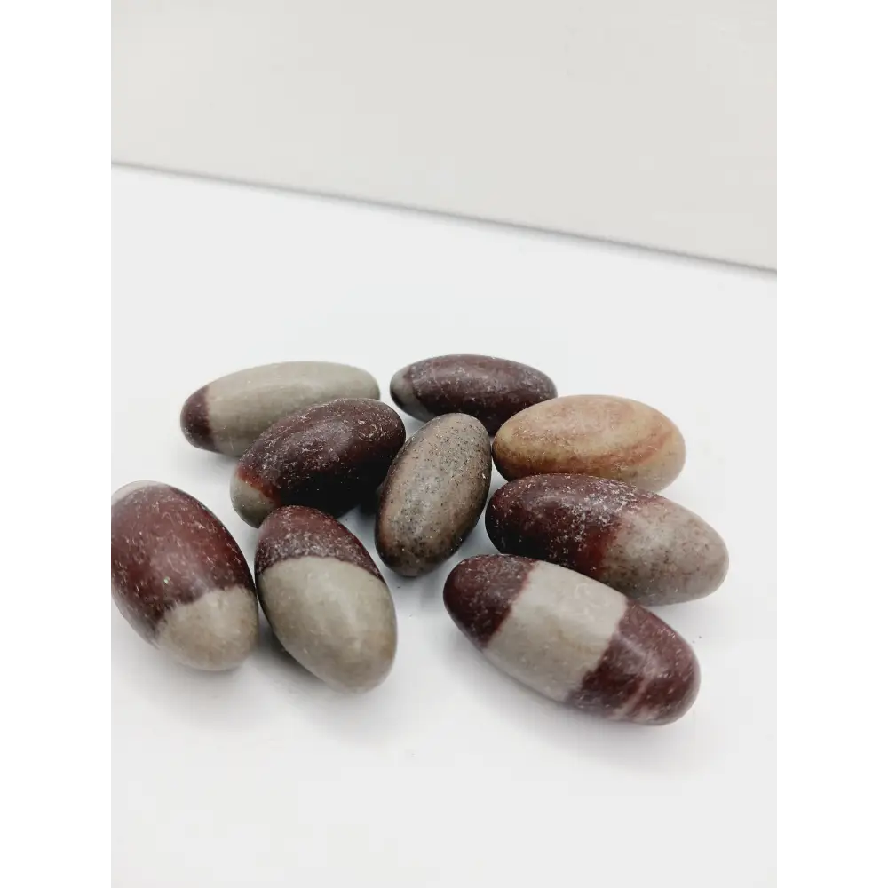 Shiva Lingam stones, polished with natural earthy patterns, available in sizes 1