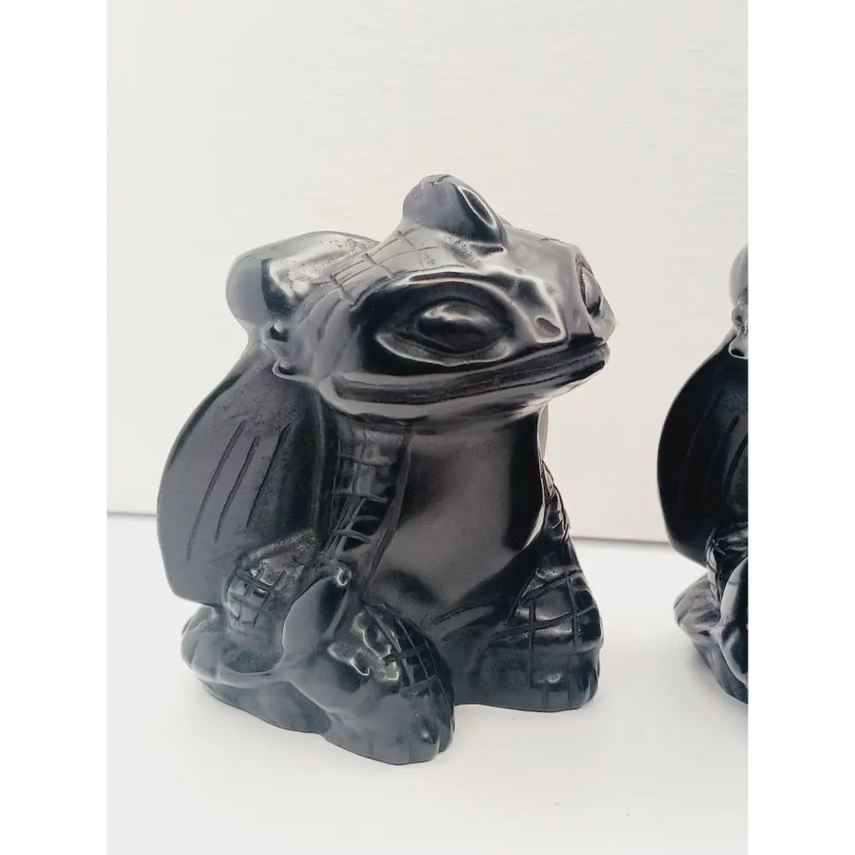 Toothless dragon carving, 3.5 inches, hand-carved from glossy black obsidian, displayed on a white background.