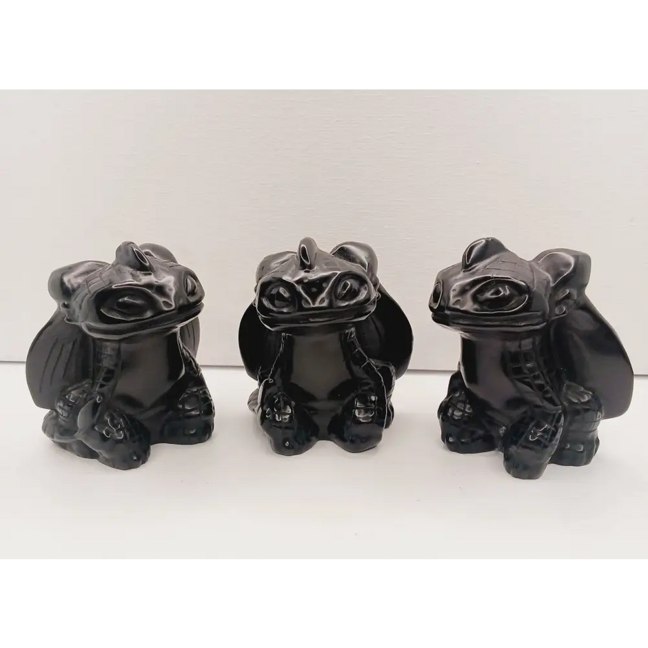 Toothless dragon carving, 3.5 inches, hand-carved from glossy black obsidian, displayed on a white background.
