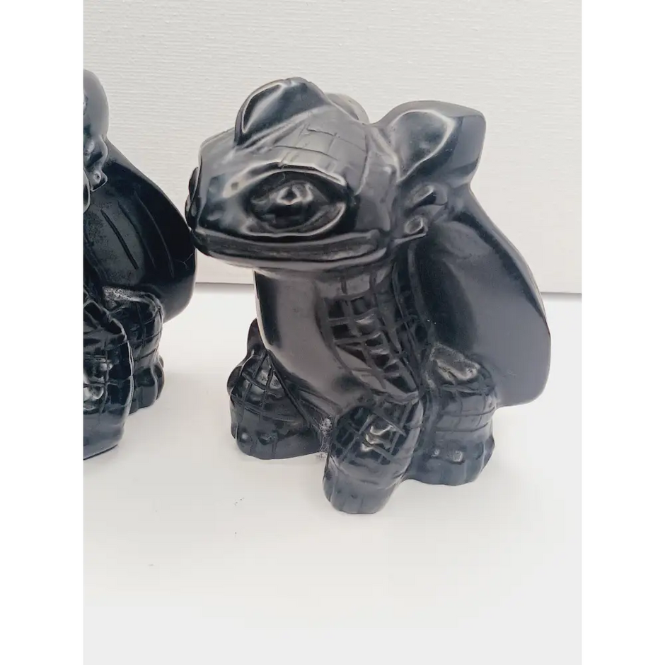 Toothless dragon carving, 3.5 inches, hand-carved from glossy black obsidian, displayed on a white background.