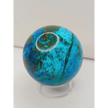 Turquoise sphere with vibrant blue-green color and natural veining, displayed on a white background.