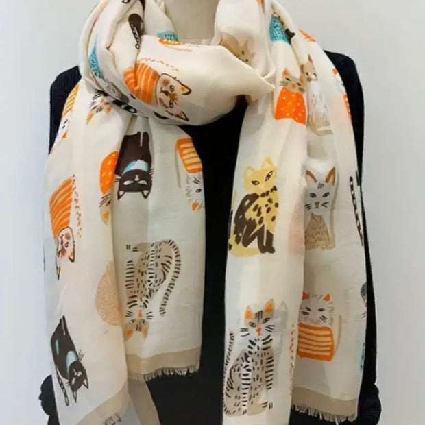 Scarf with cat pattern draped over a mannequin against a white background
